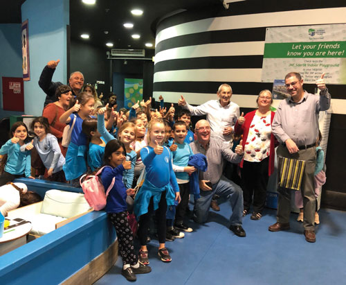 Ron and Marcie take a ‘selfie’ with some of the children inside the bomb shelter.